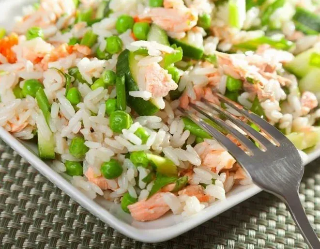 A plate of salad with pineapple and spinach